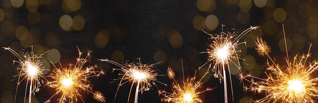 Line of lit sparklers.